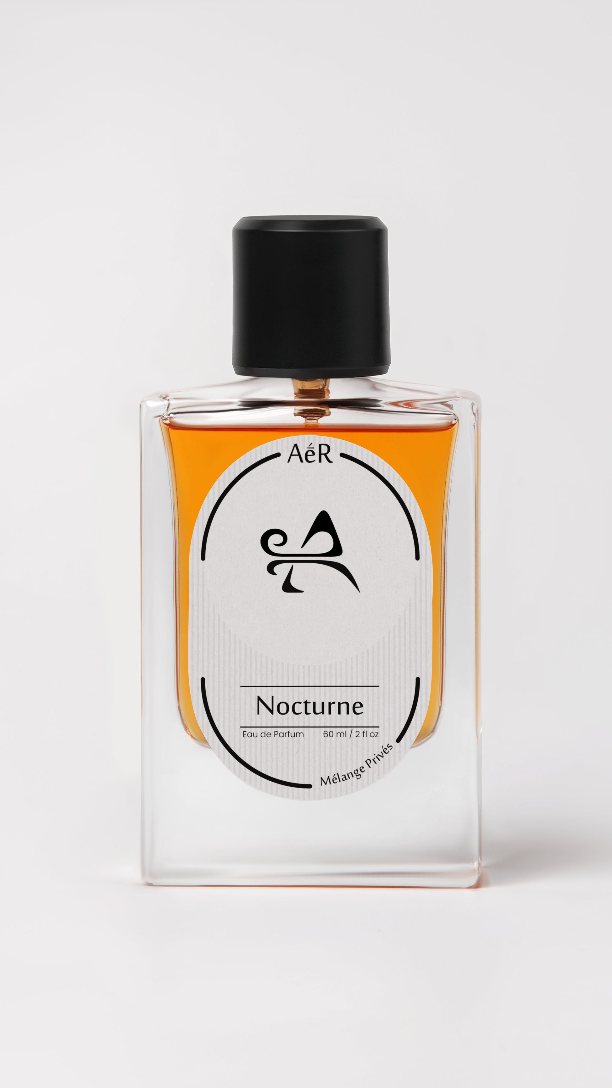 Perfume bottle labeled 'Nocturne' by AER on a white background